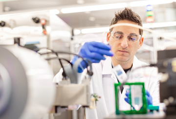 Учен в изследователска лаборатория на Амджен